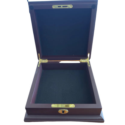 Wooden jewelry box with gold accents on a desk